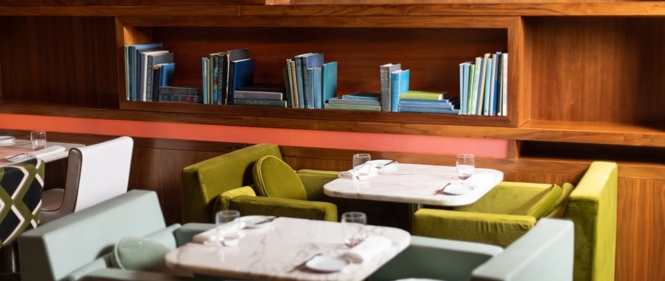 Golden, flaky Yorkshire puddings freshly baked, displayed on a metal rack.